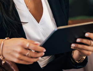 Picture of a woman working on a digital tablet.